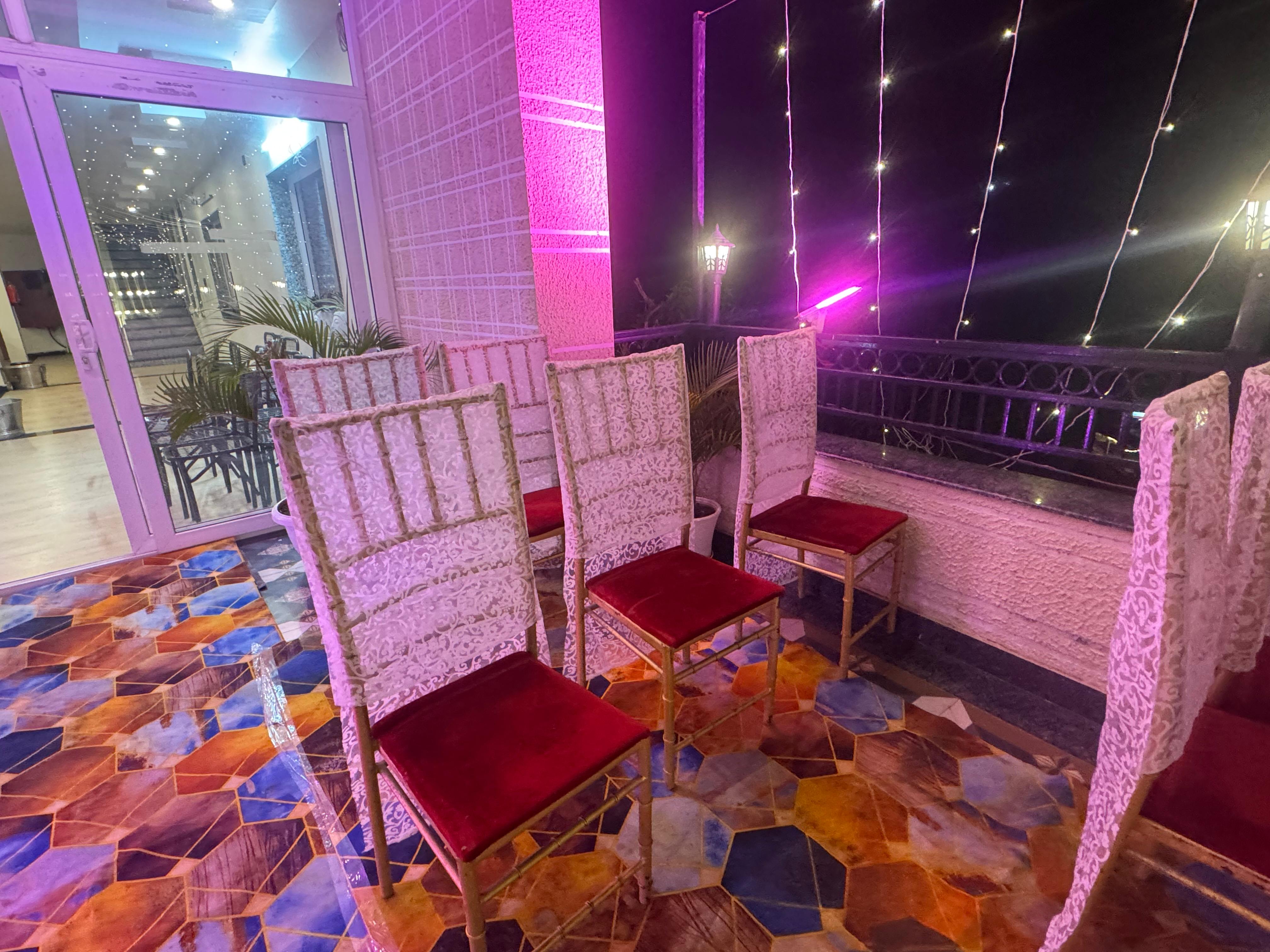 Decorated chairs under fairy lights